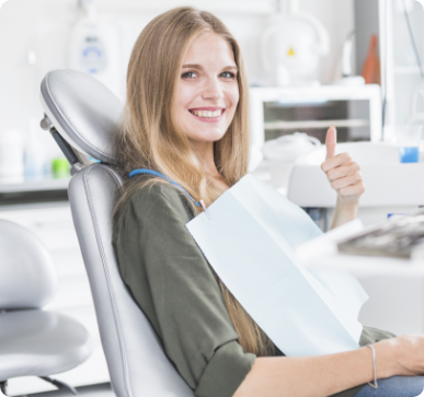 https://lovemysmiledental.ca/wp-content/uploads/2022/06/happy-young-female-patient-sitting-dental-chair-gesturing-ok-sign.png